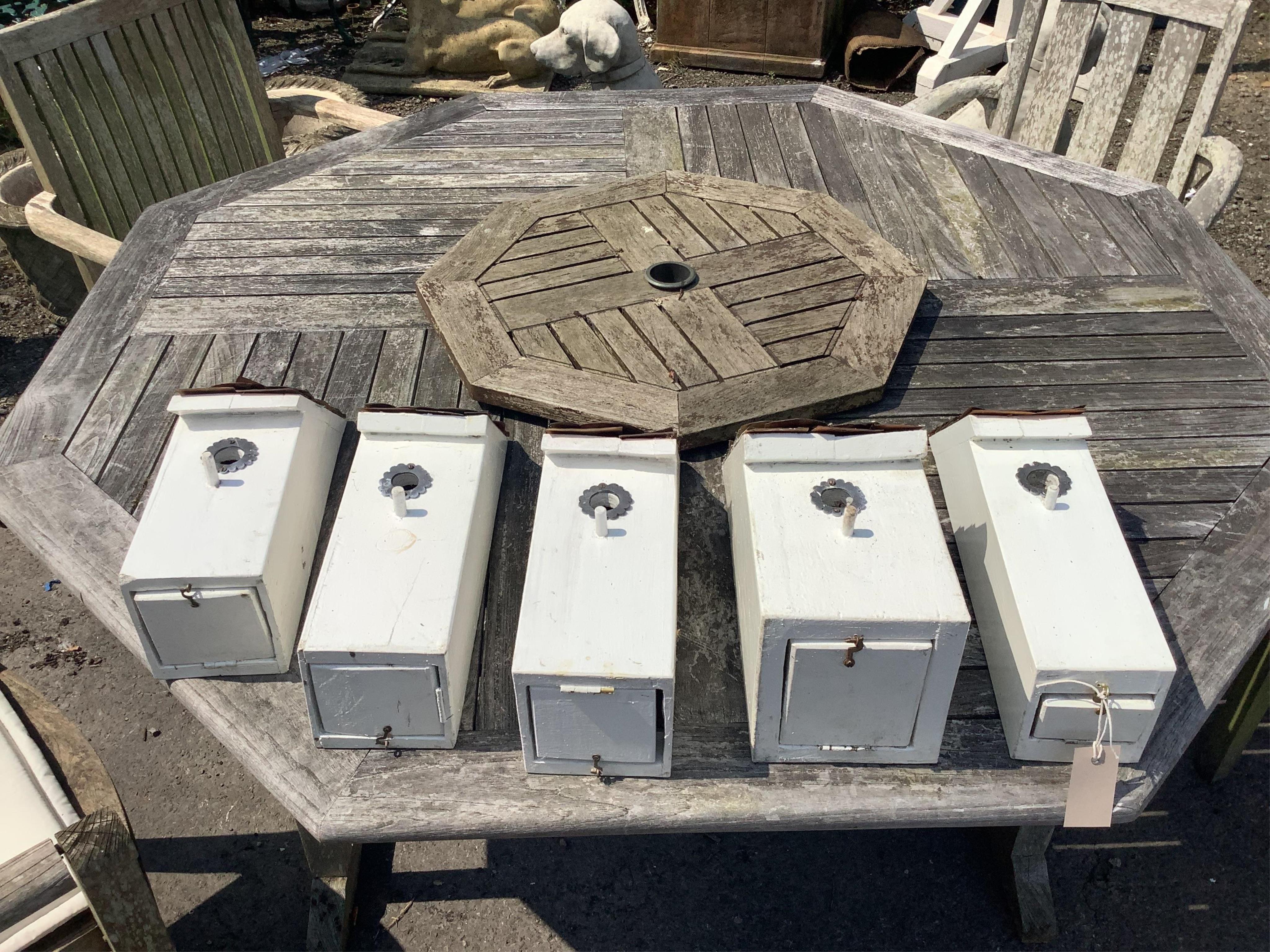 Five painted wood handmade birdboxes with shingle copper roofs, largest height 41cm. Condition - good